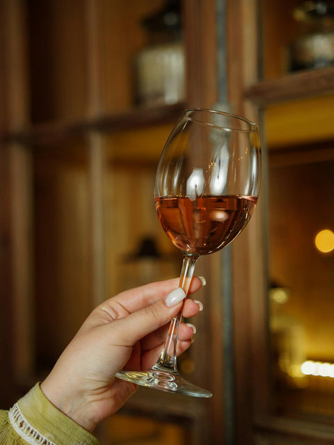 woman holding glass of wine